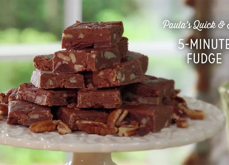 Paula Deen 5-Minute Fudge cut into squares on a plate, made with chocolate chips, marshmallows, and pecans