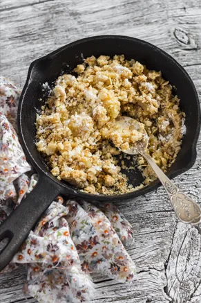 Paula Deen Apple Crisp with a golden oat crumble topping in a camp Dutch oven