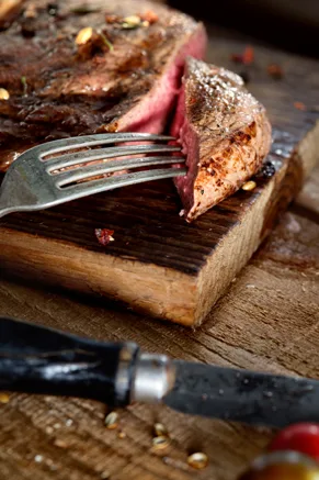 Bourbon beef tenderloin sliced on a plate with a caramelized brown sugar crust