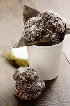 Chocolate gooey butter cookies coated in powdered sugar