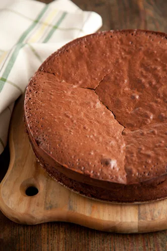 Paula Deen Chocolate Stout Cake dusted with powdered sugar on a serving plate