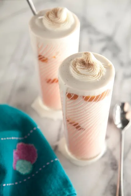 Paula Deen Cinnamon Roll Milkshake in a glass with cream cheese icing and cinnamon sugar