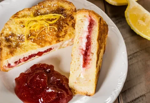 Paula Deen Cranberry French Toast made with stuffed challah bread, cream cheese, and fresh cranberries on a plate