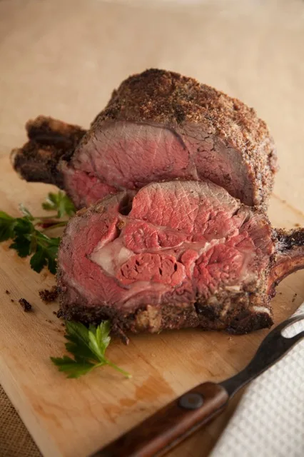 Paula Deen Foolproof Standing Rib Roast on a serving platter with a golden seared crust