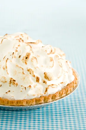 Paula Deen lemon meringue pie with golden brown meringue topping on a white plate