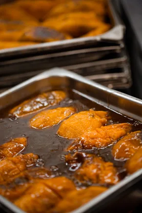 Paula Deen Ol No 7 Yams in a casserole dish with bourbon brown sugar syrup