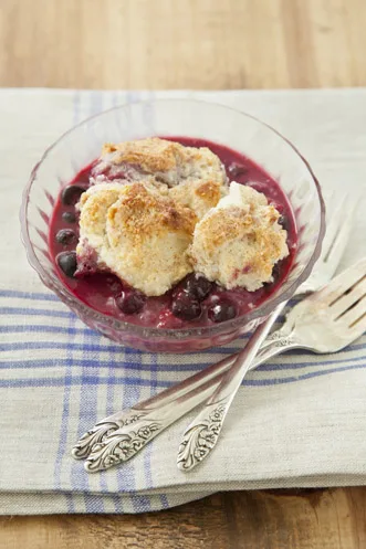 Paula Deen slow berry cobbler with golden biscuit topping in a slow cooker