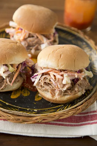 Paula Deen slow cooker pulled pork sandwiches piled on a soft bun with buttermilk coleslaw