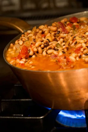 A bowl of Paula Deen spicy black-eyed peas topped with crumbled bacon