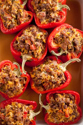Paula Deen Stuffed Red Peppers filled with ground chuck pork and rice in a casserole dish