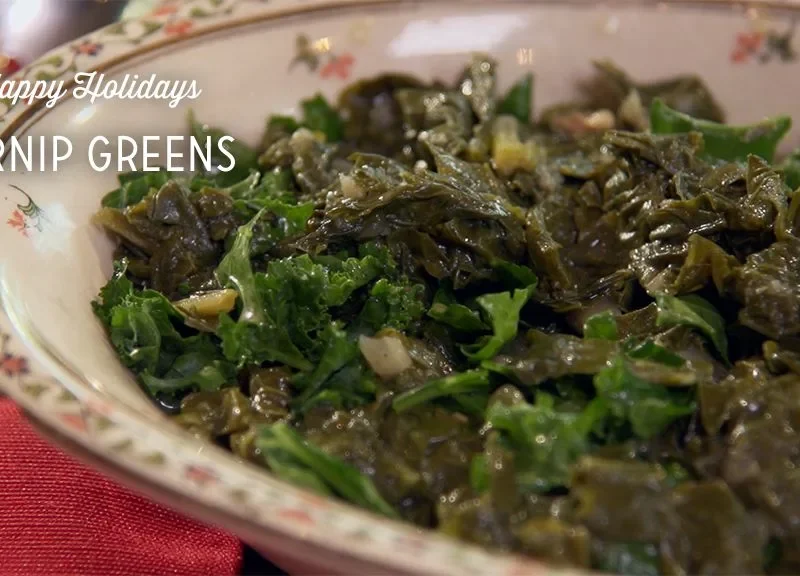 Paula Deen turnip greens simmered with a pig tail in a pot