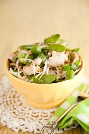 Paula Deen Asian chicken salad with diced chicken, snow peas, bean sprouts and scallions in a yellow bowl