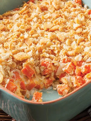 Paula Deen carrot casserole with a golden cracker topping in a teal baking dish