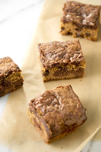 Paula Deen chocolate chip brownie bars with a swirled cookie and brownie top on parchment paper