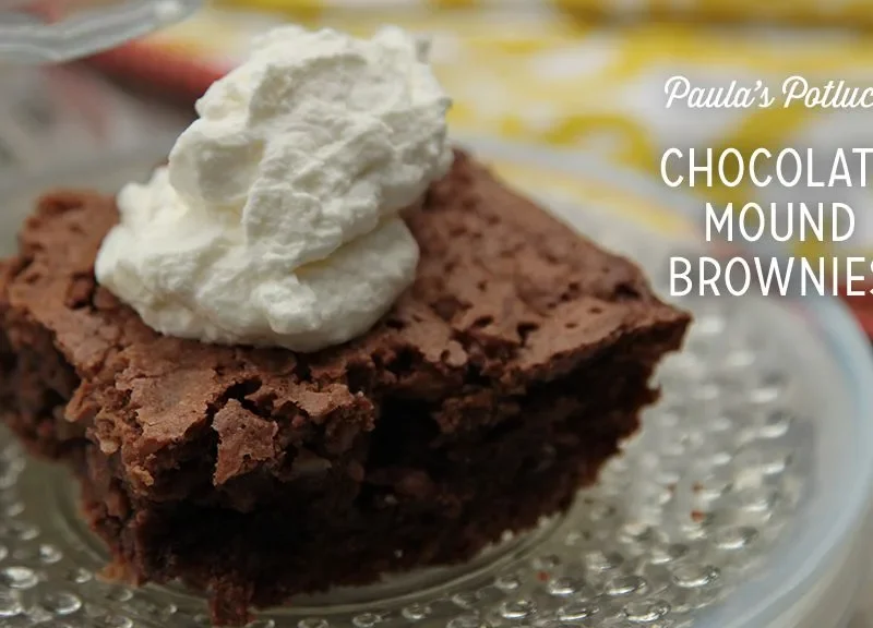 Paula Deen chocolate mound brownie square topped with a swirl of whipped cream on a glass plate