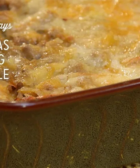 Paula Deen Christmas morning breakfast casserole baked golden with melted cheddar in a brown baking dish