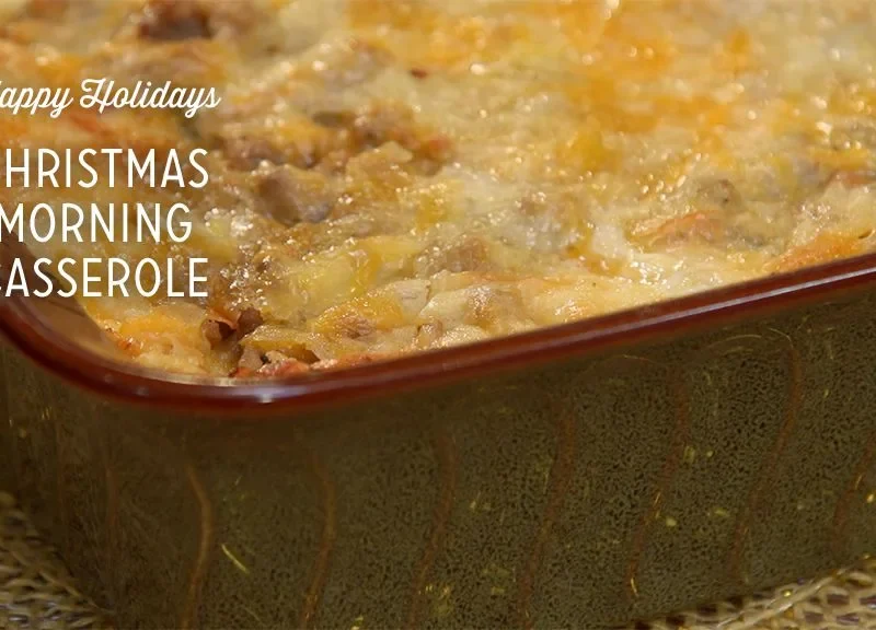 Paula Deen Christmas morning breakfast casserole baked golden with melted cheddar in a brown baking dish