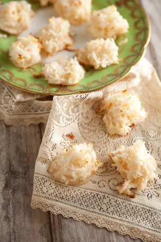 Paula Deen coconut macaroons with toasted golden edges on a green plate and a lace cloth