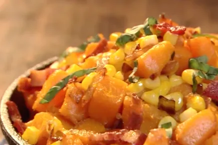 Paula Deen corn and butternut squash with crisp bacon and fresh basil in a cast iron skillet