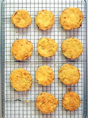 Paula Deen deep-fried squash rounds golden brown with a cornmeal crust cooling on a wire rack