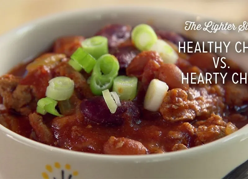Paula Deen healthy chili in a white bowl with ground turkey, kidney beans and sliced green onions on top