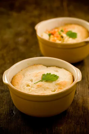 Paula Deen hurry up chicken pot pie baked in yellow ramekins with a golden biscuit topping and a parsley leaf