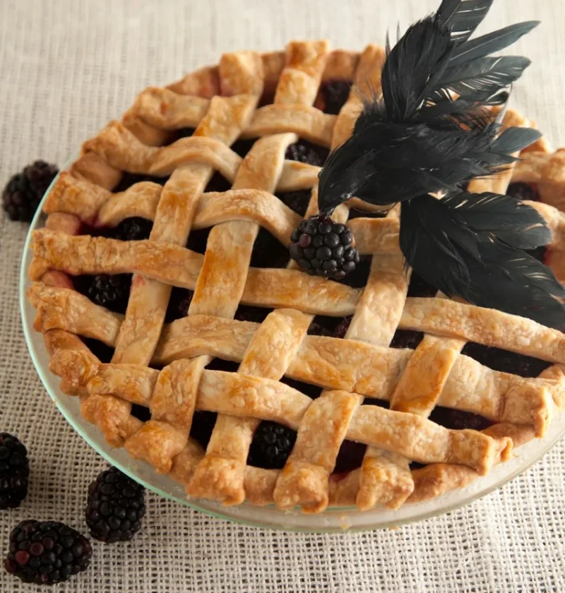 Paula Deen lattice-top blackberry blackbird pie with a golden woven crust and a black feather crow on top