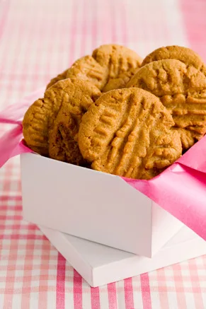 Paula Deen magical peanut butter cookies with fork crisscross tops stacked in a white gift box tied with pink ribbon