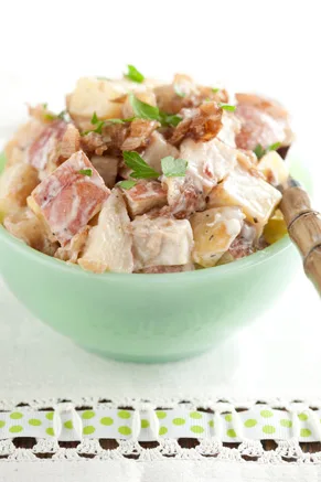 Paula Deen roasted potato salad with blue cheese dressing in a green bowl topped with fresh parsley
