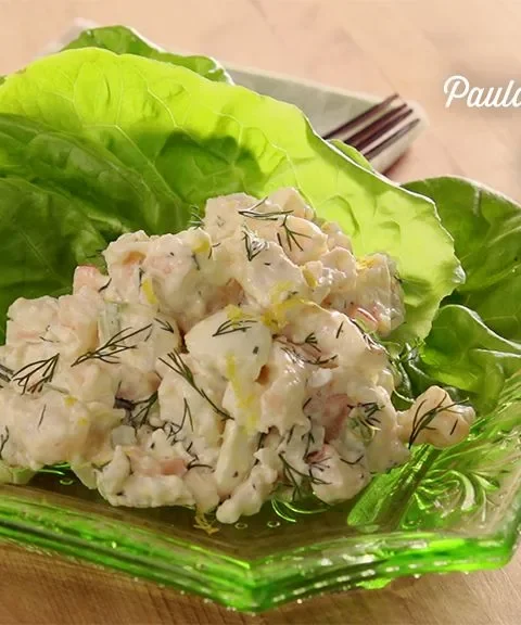 Paula Deen shrimp salad with fresh dill scooped into a Bibb lettuce cup on a green glass dish