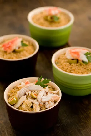 Paula Deen The Best Crab Casserole baked in green and brown ramekins topped with crab, olives and parsley