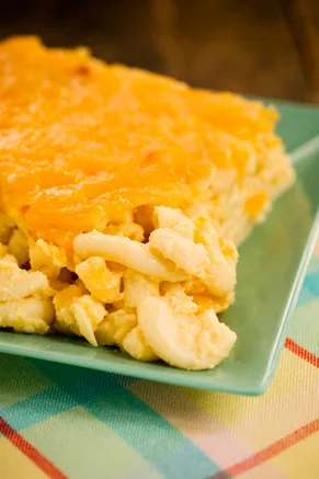 Paula Deen The Lady's Cheesy Mac, a baked cheddar macaroni casserole with a golden top on a green plate